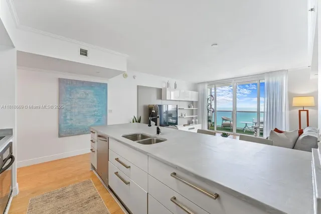 a kitchen with sink a stove and cabinets