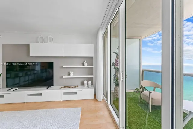 a living room with a flat screen tv and a fireplace