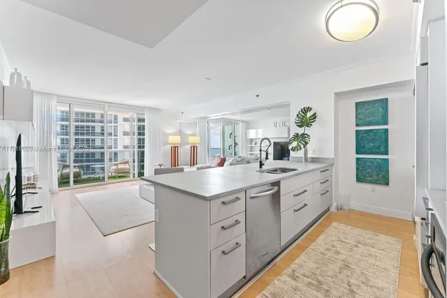 a kitchen with granite countertop a sink and a stove