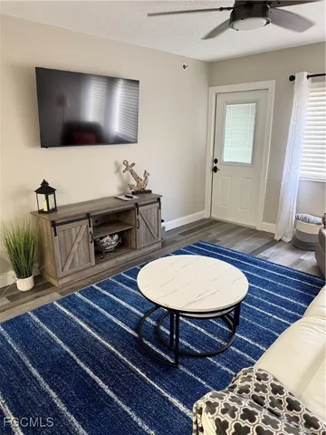 a living room with a flat screen tv and floor to ceiling window