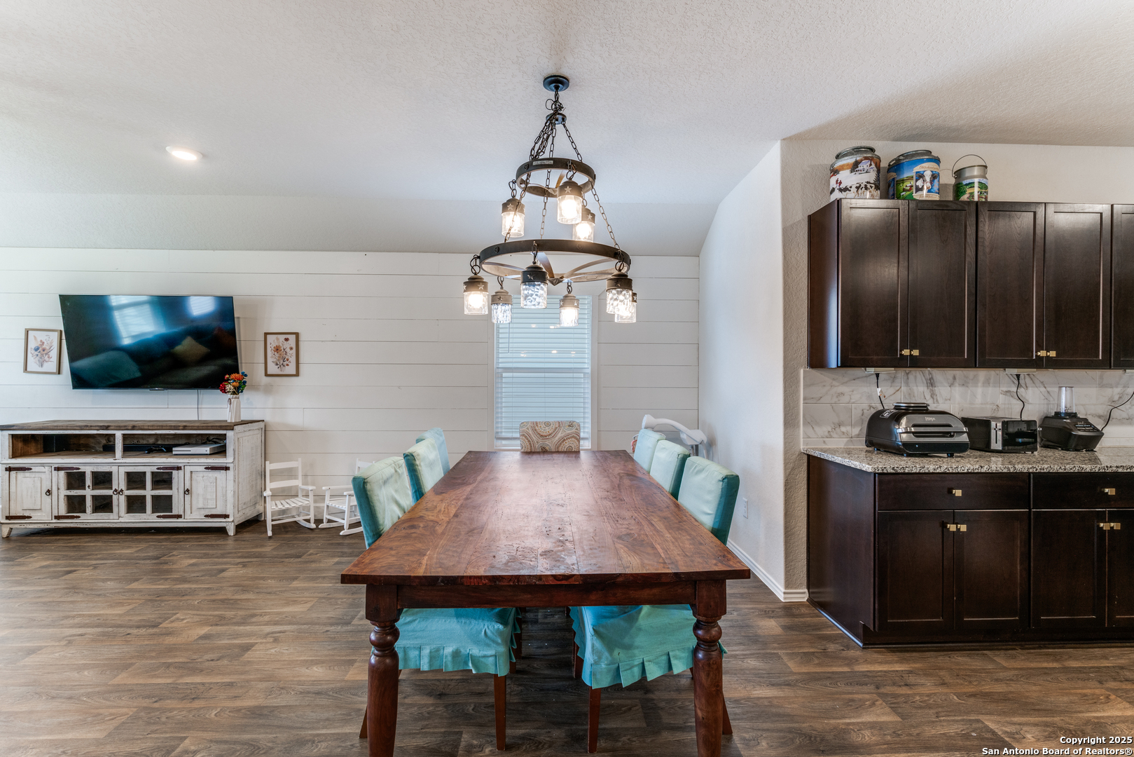 816 Indigo Way Seguin, TX 78155 - Photo 11 of 25 a kitchen with stainless steel appliances wooden floor dining table and chairs