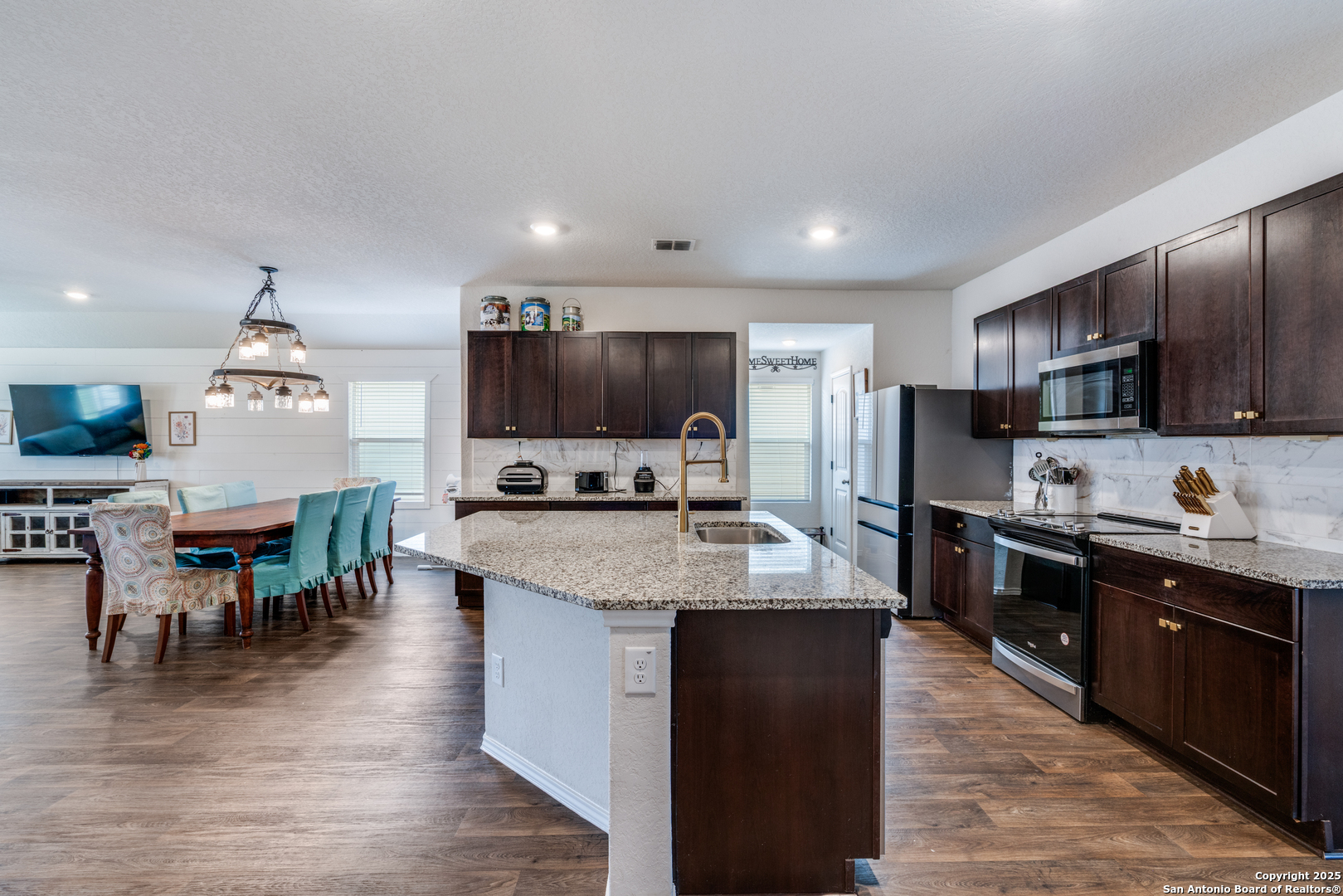 816 Indigo Way Seguin, TX 78155 - Photo 12 of 25 a large kitchen with stainless steel appliances and a view of living room