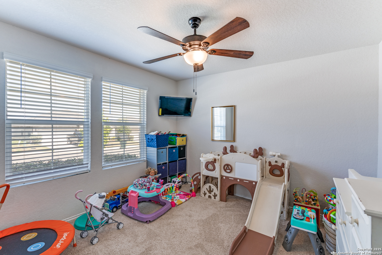 816 Indigo Way Seguin, TX 78155 - Photo 17 of 25 a bedroom with furniture a chandelier and a window