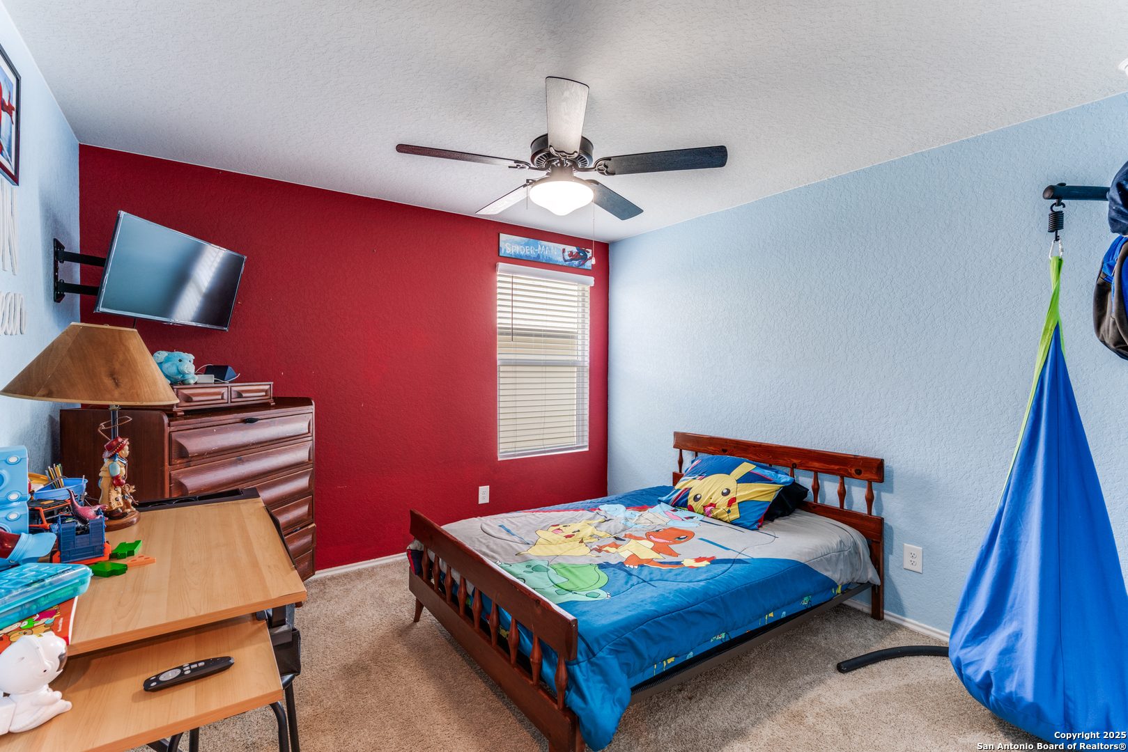 816 Indigo Way Seguin, TX 78155 - Photo 21 of 25 a bedroom with a bed and a chandelier