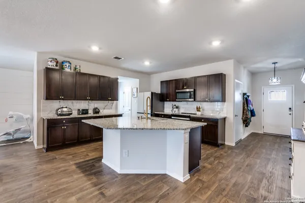 a kitchen with granite countertop stainless steel appliances and sink