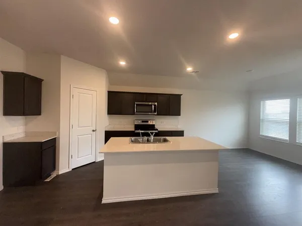 a kitchen with a stove and a microwave