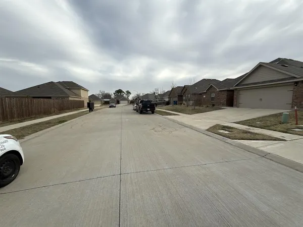 a view of a street with a car parked in front of it