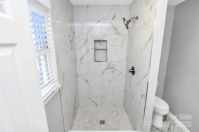 a bathroom with a toilet and shower