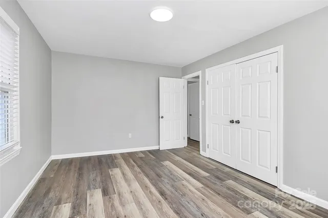 a view of a room with wooden floor and entryway
