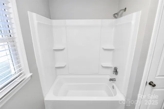 a bathroom with a white bath tub