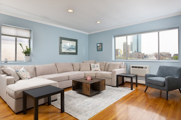 259 Beacon Street, Unit 71 Boston, MA 02116 - Photo 2 of 9 a living room with furniture wooden floor and a large window