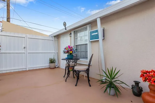 a dining room with furniture and a potted plant