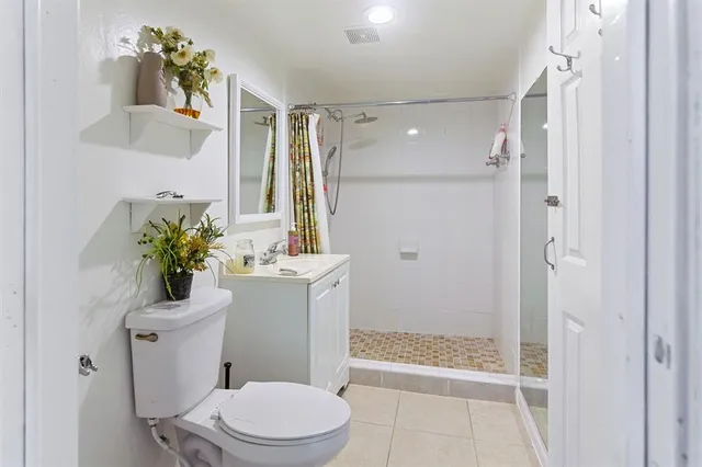 a bathroom with a sink mirror toilet and shower