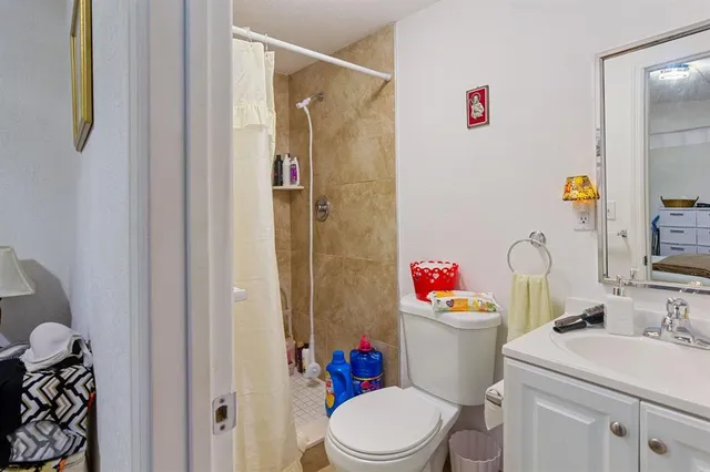 a bathroom with a sink toilet and shower