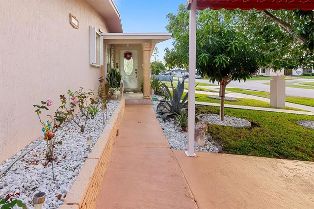 a view of a house with backyard and sitting area