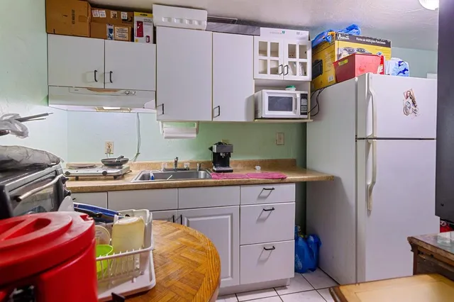 a kitchen with a cabinets and refrigerator