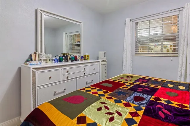 a bedroom with a bed and a dresser