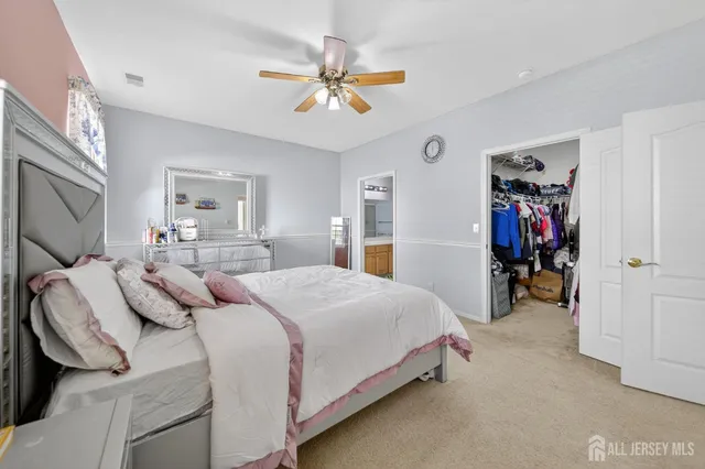 a bathroom with a sink a toilet a mirror and shower