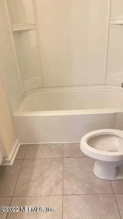 a bathroom with a toilet and a bathtub