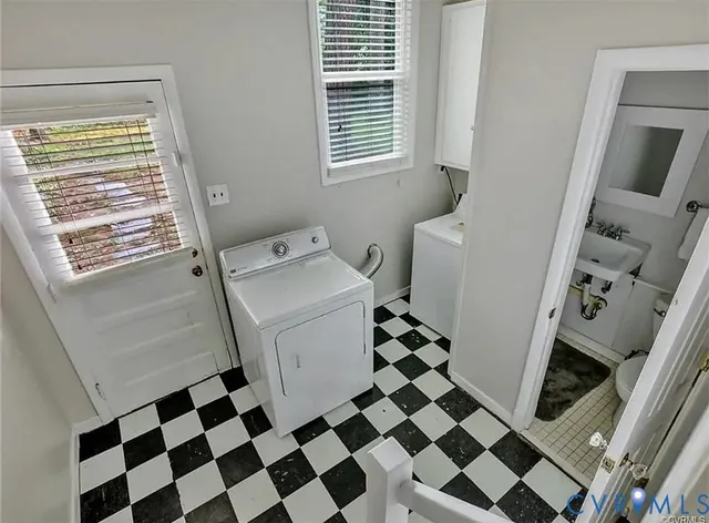 a bathroom with a black white checkered floor and a black white checkered floor