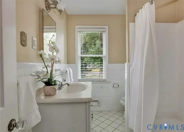 a bathroom with a sink a mirror and a toilet