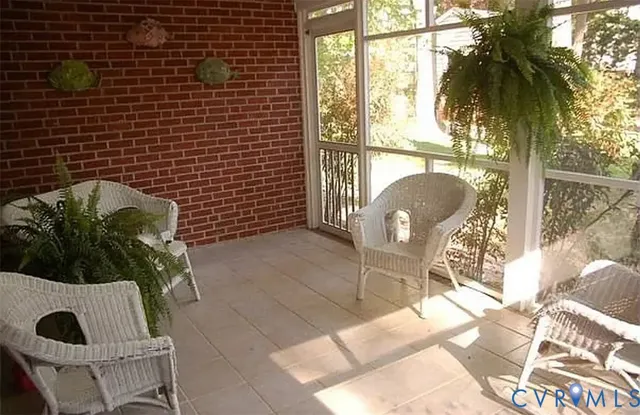 a view of a balcony with chair and a potted plant