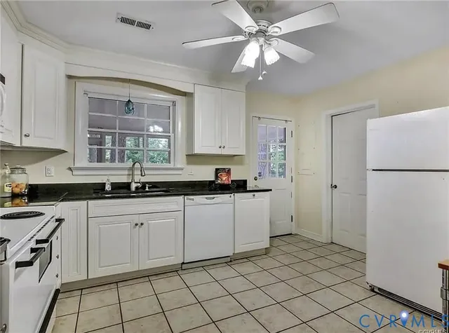 a kitchen with a sink cabinets and window