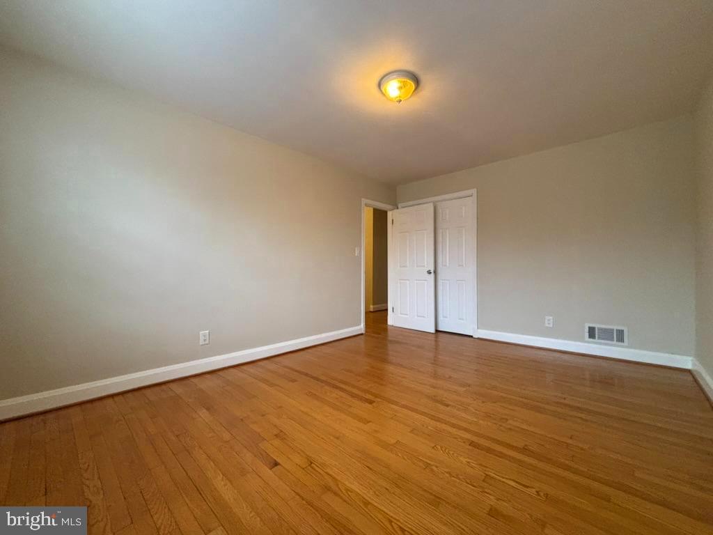 7028 Heathfield Road Baltimore, MD 21212 - Photo 12 of 23 a view of an empty room with wooden floor and window