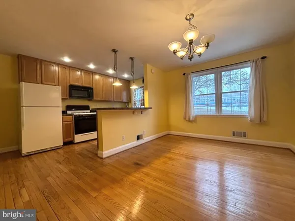 a view of a kitchen with a sink a microwave and refrigerator