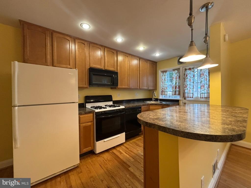 7028 Heathfield Road Baltimore, MD 21212 - Photo 8 of 23 a kitchen with stainless steel appliances granite countertop a refrigerator a stove a sink dishwasher and a refrigerator
