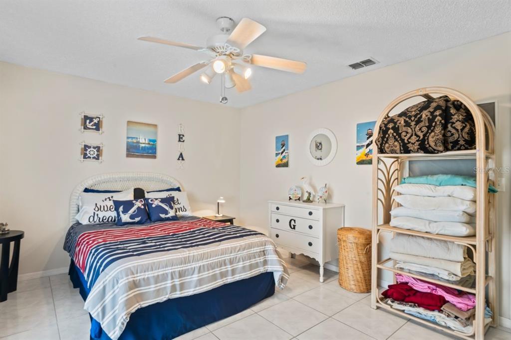 6101 Elmhurst Drive, Unit 5B New Port Richey, FL 34653 - Photo 19 of 45 a bedroom with a bed and a dresser