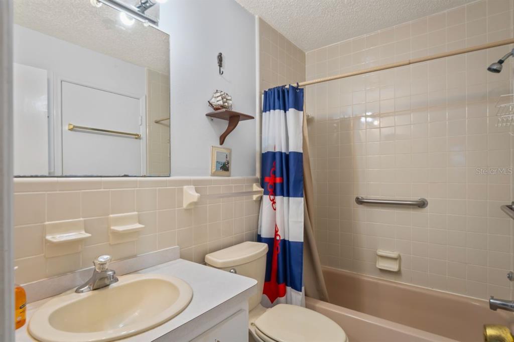 6101 Elmhurst Drive, Unit 5B New Port Richey, FL 34653 - Photo 21 of 45 a bathroom with a sink toilet and shower