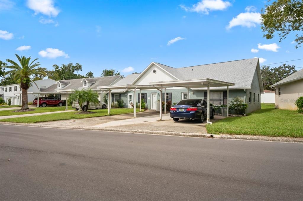 6101 Elmhurst Drive, Unit 5B New Port Richey, FL 34653 - Photo 26 of 45 a front view of a house with a garden and parking