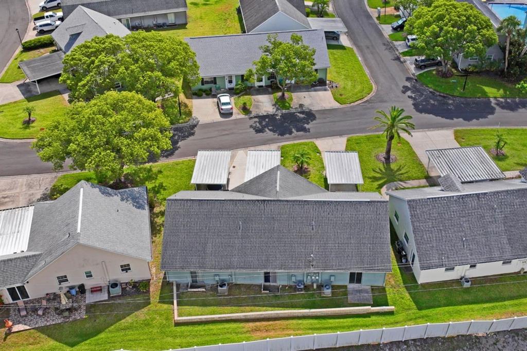 6101 Elmhurst Drive, Unit 5B New Port Richey, FL 34653 - Photo 30 of 45 an aerial view of multiple houses with yard