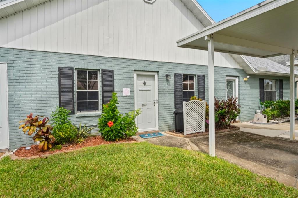 6101 Elmhurst Drive, Unit 5B New Port Richey, FL 34653 - Photo 4 of 45 a front view of a house with a porch