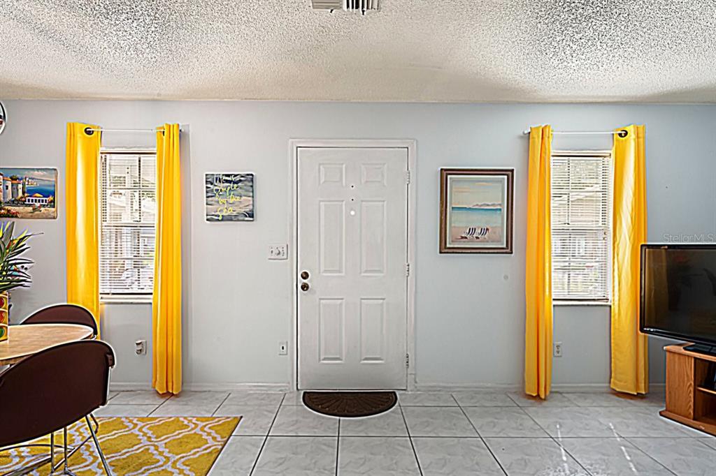 6101 Elmhurst Drive, Unit 5B New Port Richey, FL 34653 - Photo 5 of 45 a view of a livingroom with furniture and a window
