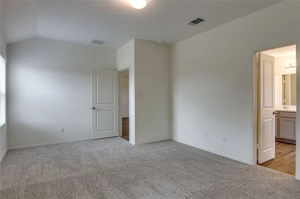 a view of an empty room and a window