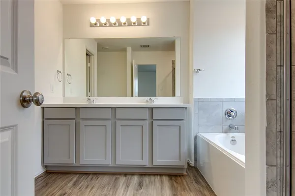 a bathroom with a bathtub and a sink