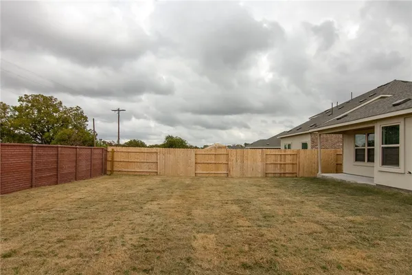 a big house with a big yard and large trees
