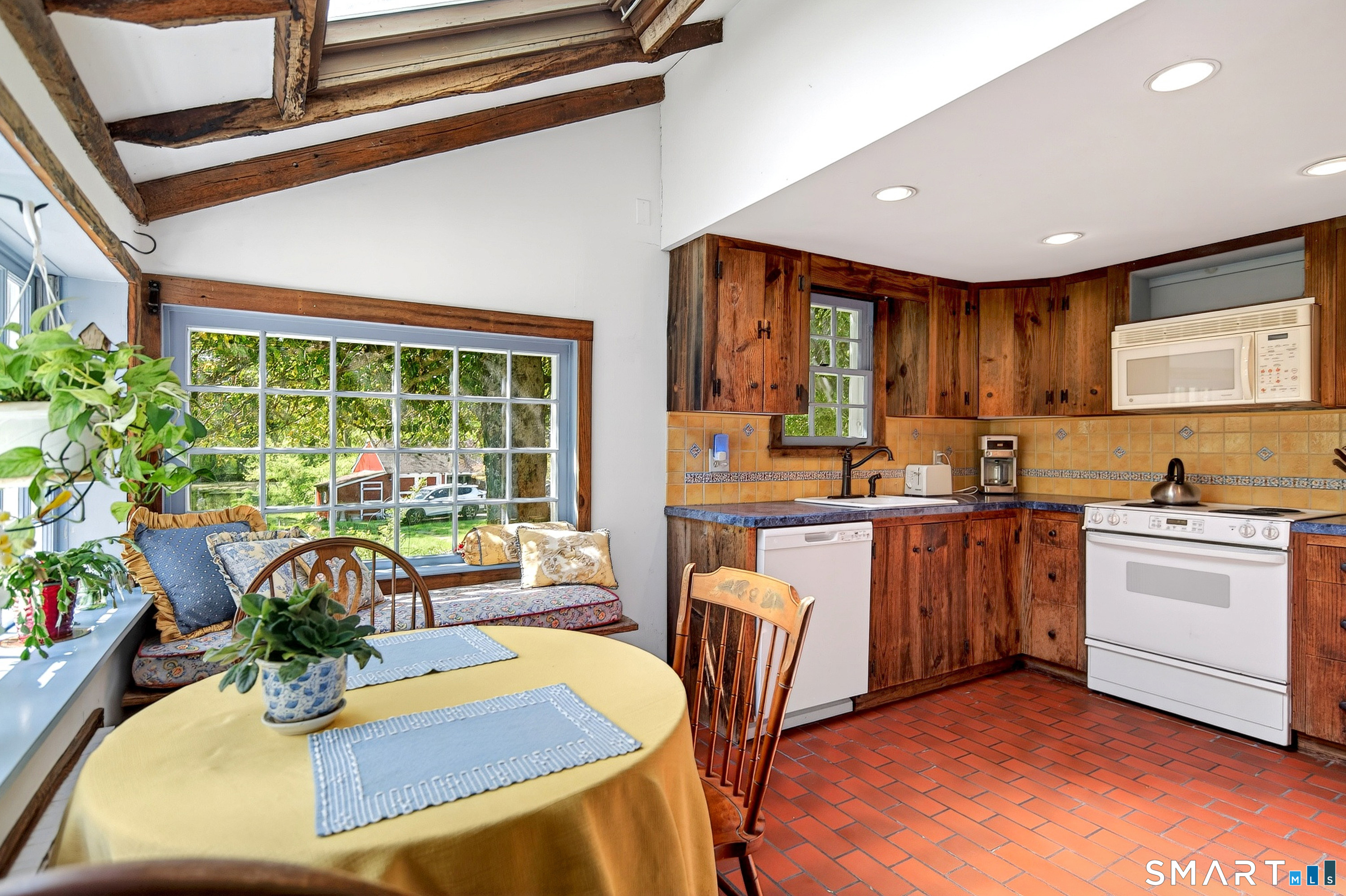 6 High Rock Road Newtown, CT 06482 - Photo 13 of 40 a kitchen with sink a refrigerator and chairs