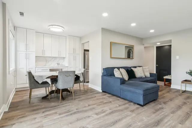 a living room with furniture and a wooden floor