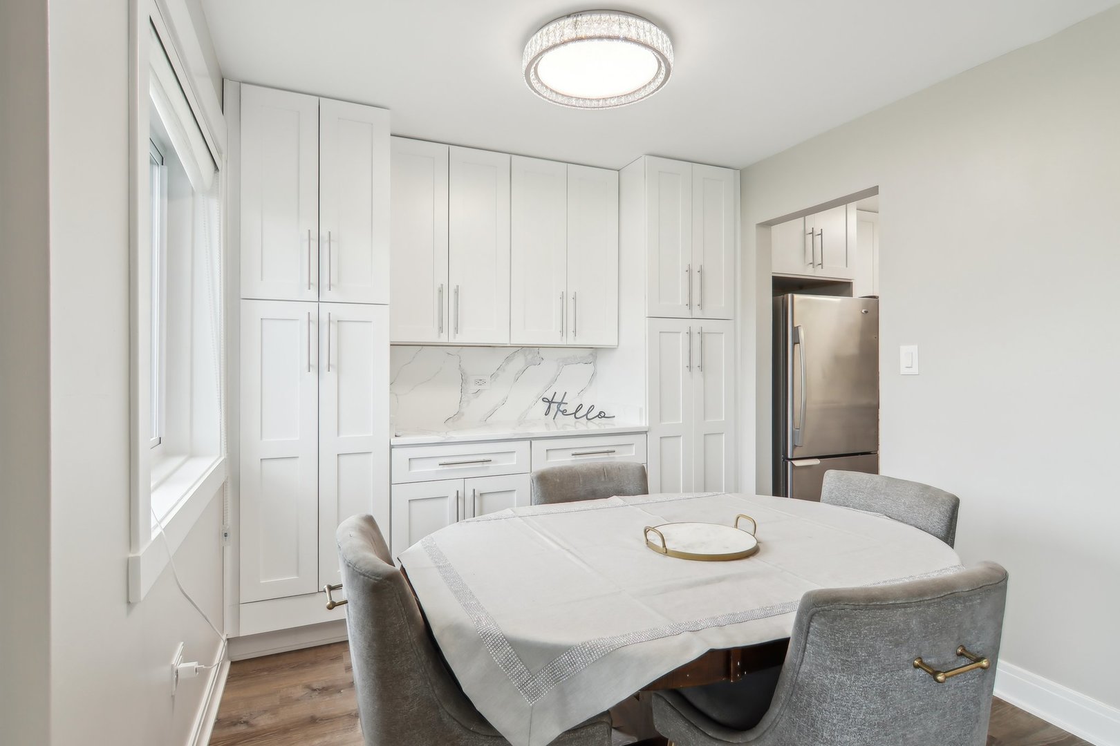 5704 West 128th Street, Unit 1C Crestwood, IL 60418 - Photo 20 of 29 a kitchen with stainless steel appliances kitchen island a table chairs and refrigerator