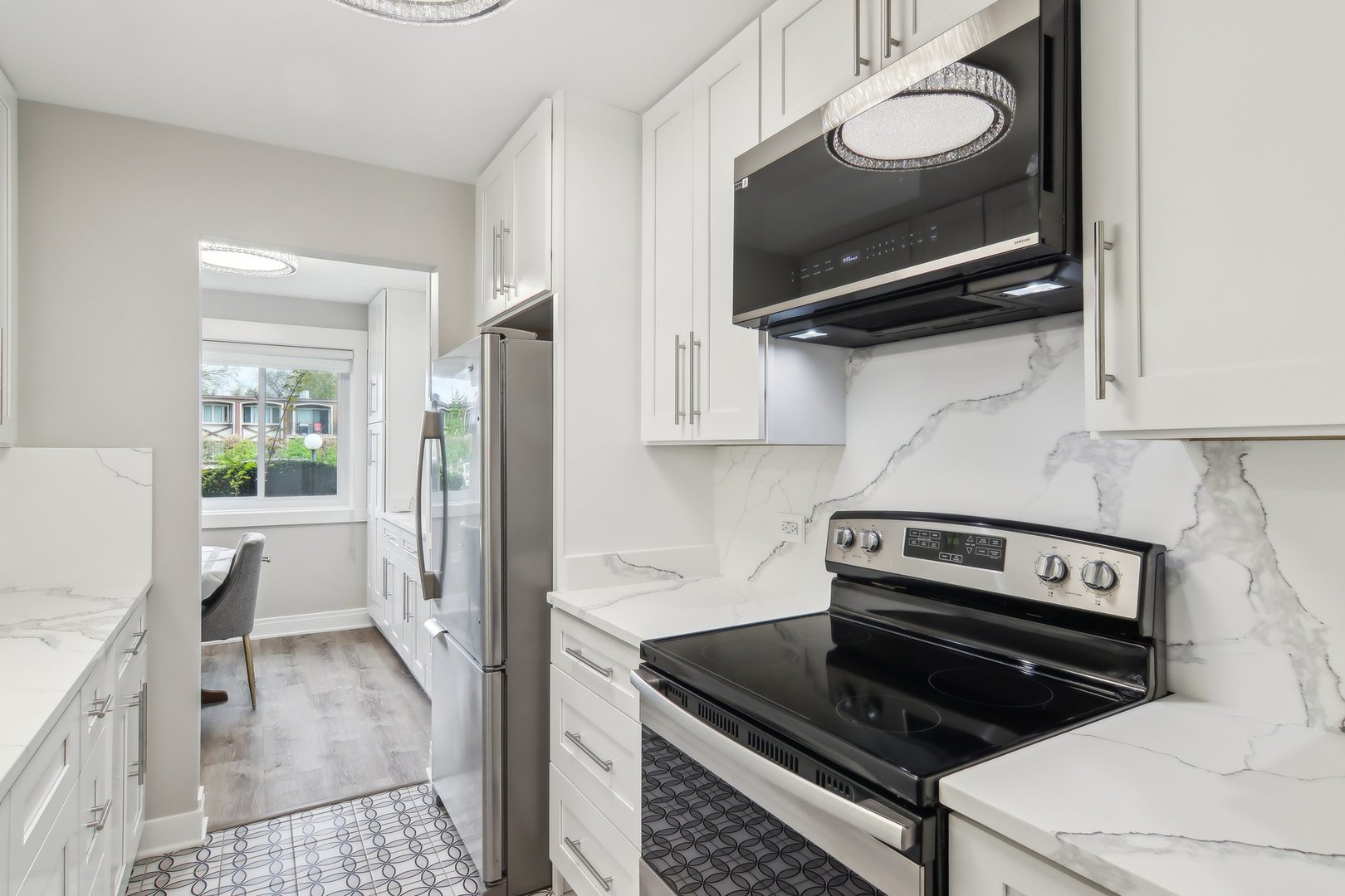 5704 West 128th Street, Unit 1C Crestwood, IL 60418 - Photo 24 of 29 a kitchen with stainless steel appliances a stove a microwave and a refrigerator