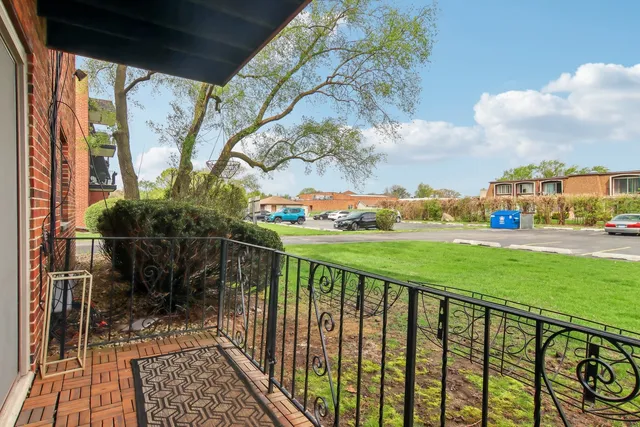a view of a balcony with yard