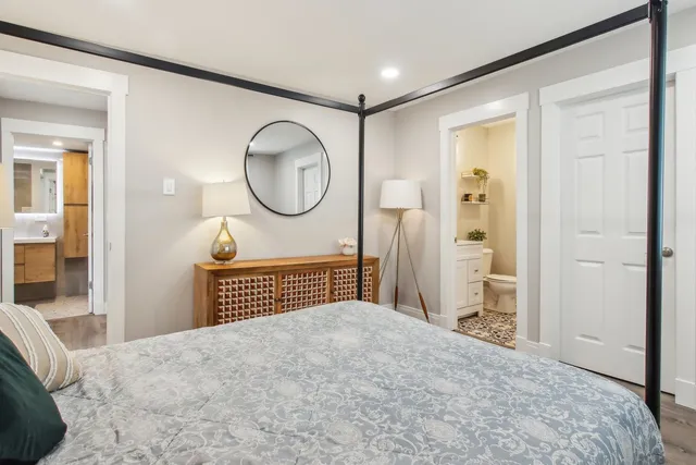 a bedroom with a large bed and a chandelier