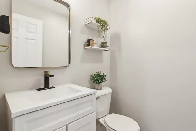 a bathroom with a sink a toilet and mirror