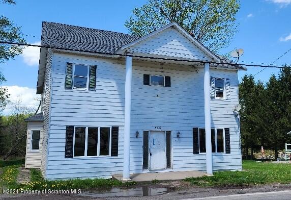 a front view of a house with a garden