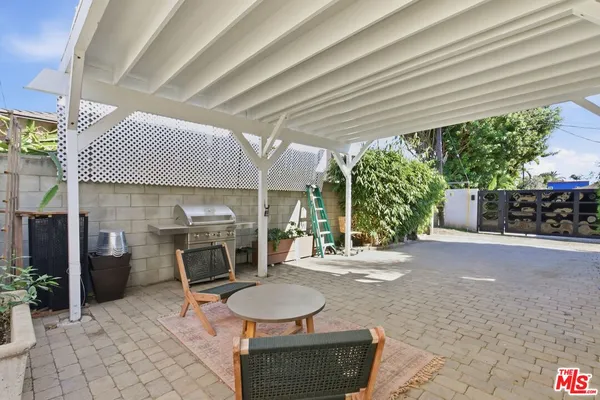 a room with patio furniture and a grill