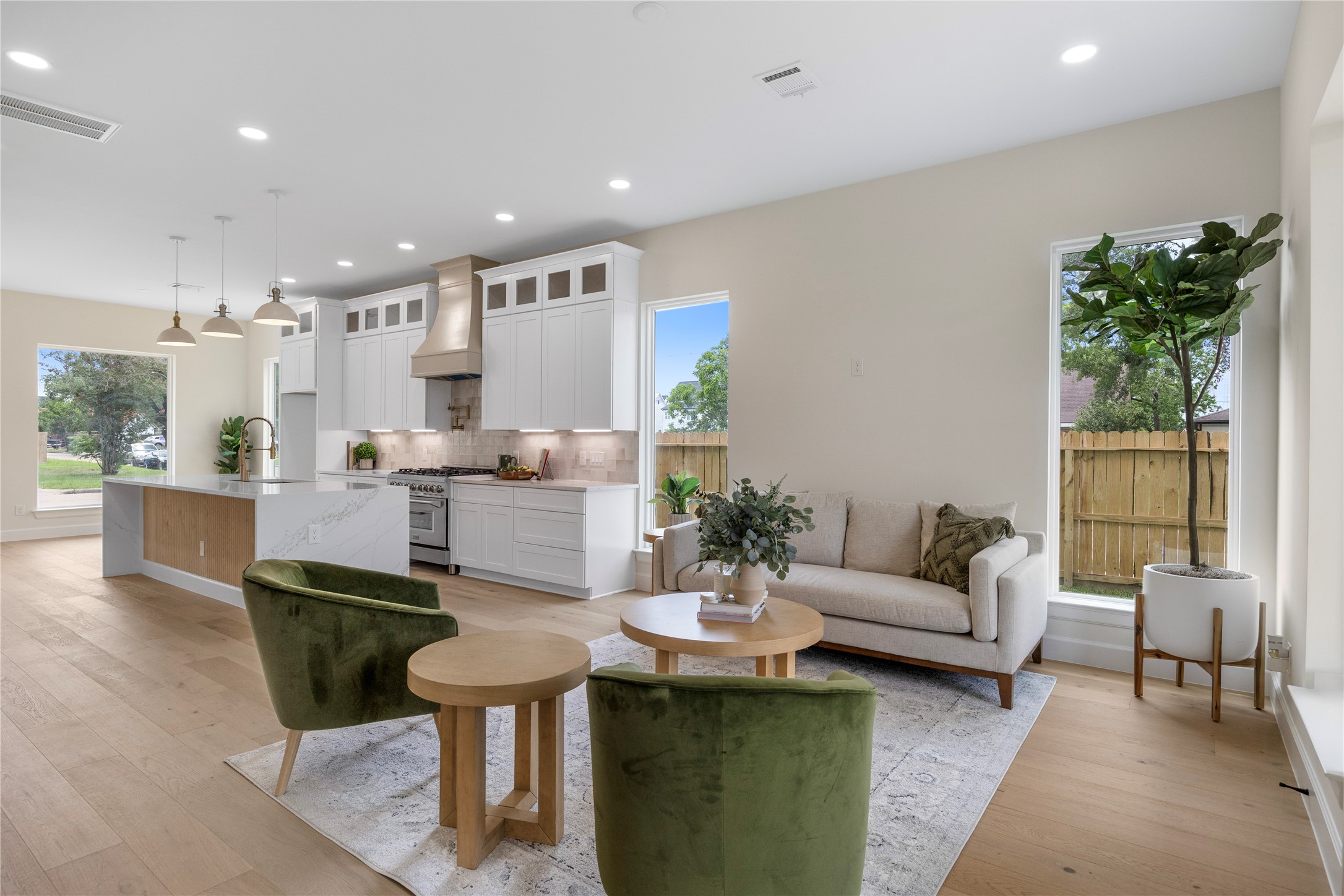 8646 Alcott Drive Houston, TX 77080 - Photo 13 of 44 a living room with furniture a potted plant and kitchen view