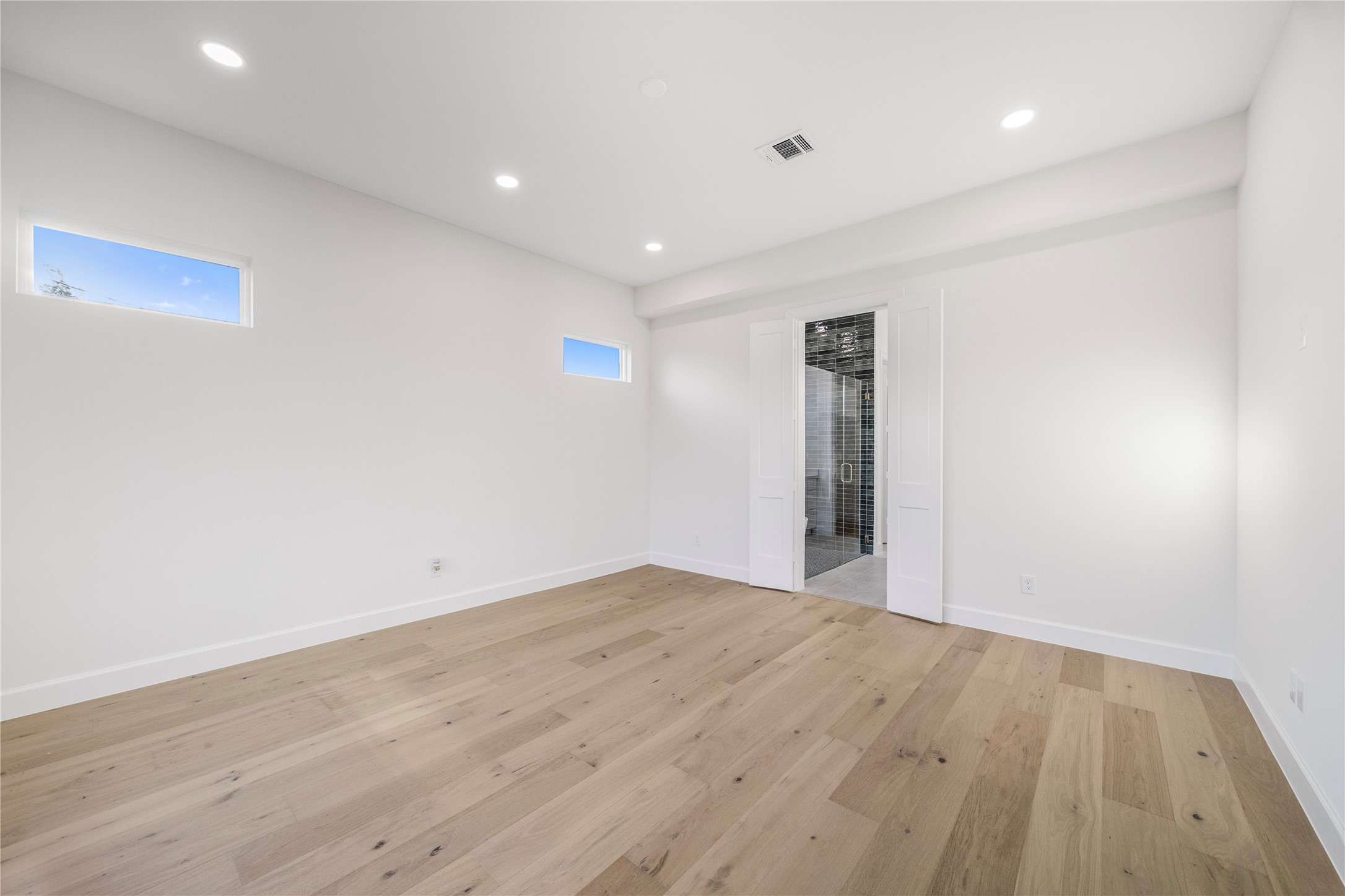 8646 Alcott Drive Houston, TX 77080 - Photo 16 of 44 an empty room with wooden floor and natural light